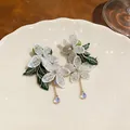 Detailed view of lace flower earrings with pearls and iridescent water-drop pendants - Flower Water Drop Style / Silver Needle White Green