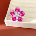 Detailed view of an elegant flower ring featuring vibrant pink zircons in a jewelry box - Open Design / Silver-Pink