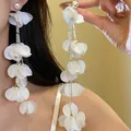 Detail shot of long tassel earrings with white shell petals and pearl studs being worn - Vintage Pearl Shell Texture Tassel Style (58) / White
