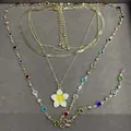 Elegant multi-layered gold-tone necklace featuring colorful crystals and a sweet white flower - Gold-Yellow-Multicolor