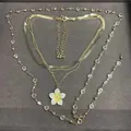 Sweet multi-layered gold-tone necklace with a white and yellow plumeria flower pendant - Gold-Yellow-Transparent
