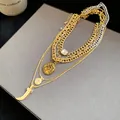 Close-up of retro shiny multi-layered metal necklace with coin and crystal pendants - Multi-layer Coin Horn Style (HN11995) / Gold-Silver