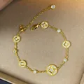 Detail of gold-plated bracelet with sparkling round zircon charms on beige background - Bracelet-Gold Plated / Gold