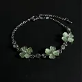 Close-up of elegant green cat eye stone clover bracelet with sparkling crystal accents - Silver/Green
