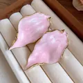 Elegant pink leaf-shaped stud earrings with gold wavy trim displayed on beige jewelry tray - Wrinkled Leaf Studs / Pink