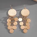 Close-up of oversized gold-tone chandelier earrings with tiered metallic round sequins. - Hook Style (HE22946) / Gold