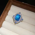 Close-up detail of a vintage palace style ring with a rectangular blue zircon stone. - Open Ring (HR3579) / Blue