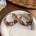 Detailed view of colorful glass beaded hoop earrings with silver needle posts - Silver / Large / Colorful