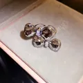 Detail view of a silver butterfly bow ring with sparkling faceted crystals in a box - Silver-Grey