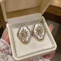 Vintage palace style flower earrings with rhinestones and mother of pearl inlay. - White / Gold