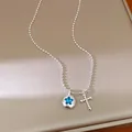 Detail shot of silver bead chain necklace with blue star rhinestone and cross pendants - Star Round Tag Cross Pendant / Silver-Iridescent