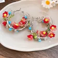 Vibrant dopamine style hoop earrings with red floral glass beads and silver posts - Silver / Red