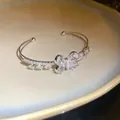Detailed macro view of an elegant silver butterfly bangle with sparkling zircons - Silver