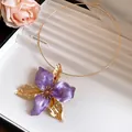 Detailed close-up of a vintage purple enamel flower choker necklace with golden petals - Necklace / Purple