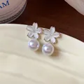 Macro detail of elegant French style cherry blossom and white pearl drop earrings - Cherry Blossom Style (White) / Silver