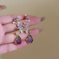 Elegant purple teardrop tassel earrings featuring intricate floral crystal accents and golden finish - Purple Floral Tassel (24#)