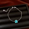 Close-up of a silver chain bracelet featuring a sparkling square blue zircon stone - Exquisite Bracelet / Light Blue