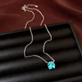 Macro detail of a minimalist silver chain necklace featuring a brilliant square blue zircon pendant - Choker Necklace / Light Blue