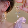 Silver needle waterdrop tassel earrings with crystal pendants on model's ear - Aurora Waterdrop Tassel (45#)