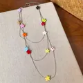 Detailed close-up of a triple-layered silver chain necklace with vibrant resin flowers - Three-Layer Stacking Style (HN12336) / Silver - Rainbow