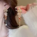 Elegant silver needle long tassel earrings featuring amber beads and golden floral accents - Gradient Coffee Beaded (56#)