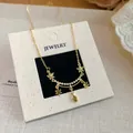 Close-up of 18k gold plated necklace featuring green zircon flowers and teardrops - Flower Water Drop Clavicle Chain / Gold-Green