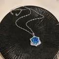 Close-up of a vintage court style necklace featuring a large blue zircon in a star pendant - Hexagonal Star Style (HN11764)