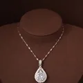 Vintage silver-tone teardrop necklace with sparkling zircon on a brown jewelry bust. - Water Drop Halo Style (HN11764)