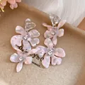 Macro detail of pink acetate flower earrings with shimmering rhinestones and heart studs - Flower Tassel Drop Earrings / Pink