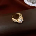 Detailed view of a luxury gold-plated open ring with a round zircon centerpiece. - Round Zirconia Twisted Pattern Open Ring / Gold