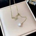 Detailed view of 18k gold plated butterfly necklace with sparkling zircons and a pearl - Gold