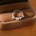 Close-up of silver fidget ring with sparkling cubic zirconia beads in jewelry box - Silver
