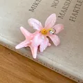 Close-up detail of a summer pink starfish and fabric flower hair clip with dewdrop accents - Duckbill Hair Clips / Pink