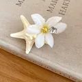 Detailed macro view of a summer starfish and flower hair clip with realistic dewdrop accents - Duckbill Hair Clips / White