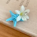Detailed view of summer starfish and flower hair clip with sparkling dewdrop accents - Duckbill Hair Clips / Blue