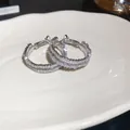 Elegant silver needle hoop earrings featuring brilliant micro-paved cubic zirconia - Silver