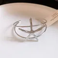 Detailed close-up of a silver metallic starfish motif on an elegant open cuff bracelet. - Starfish Style (HB5926) / Silver