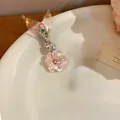 Fermaglio per capelli floreale in acetato iridescente con coda di sirena e perle - Rosa