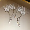Detailed view of elegant butterfly lace ear cuffs featuring iridescent crystal drops - Ear Hook / Silver-White
