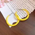 Vibrant yellow enamel C-shaped hoop earrings with blue polka dots and silver needles - 4cm / Yellow