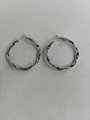 Elegant silver-toned wavy hoop earrings featuring micro-pave cubic zirconia stones for women. - Silver (Silver Earring Post)