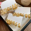 Retro gold flower and water-drop stud earring set displayed on elegant white cards - Eighteen-Piece / Silver Needle / Gold