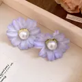 Close-up detail of romantic lavender fabric flower earrings with white pearl centers - Light Purple
