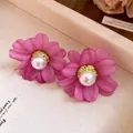 Detailed view of elegant retro pink fabric flower stud earrings with a central white pearl - Purple