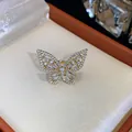 Macro view of a sparkling gold butterfly ear clip with zircon stones in a gift box. - Ear Cuff (HE31495) / Single Piece / Gold