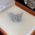 Close-up of a sparkling silver-tone zircon butterfly ear cuff displayed in a jewelry box - Ear Cuff (HE31495) / Single Piece / Silver