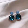 Close-up detail of vintage square stud earrings with faceted deep blue crystals on satin - Square Zirconia Style / One Pair / Silver Earring Post - Silver - Blue