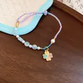 Hand-woven colorful cord bracelet with white pearls and a four-leaf clover flower charm. - Four-Leaf Clover Style
