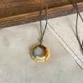 Close-up of ethnic style wooden circular pendant with colorful thread wrap details - Round Wound Style(HN12314) / Coffee