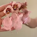 Macro view of delicate pink chiffon flower tassel earrings with fine embroidery details - Silver Earring Post Style / Pink